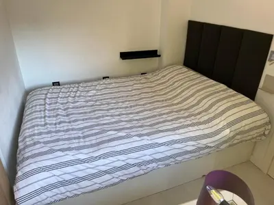 a bed in a room with a striped bedsheet at Plaza del Carmen Boutique in Valencia