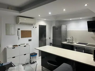a kitchen with a white counter and a refrigerator at Plaza del Carmen Boutique in Valencia