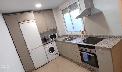 a kitchen with a white refrigerator and a dishwasher at TU CASA en Benetússer , VALENCIA in Benetúser