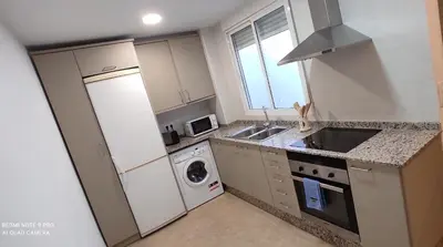 a small kitchen with a sink and a dishwasher at TU CASA en Benetússer , VALENCIA in Benetúser