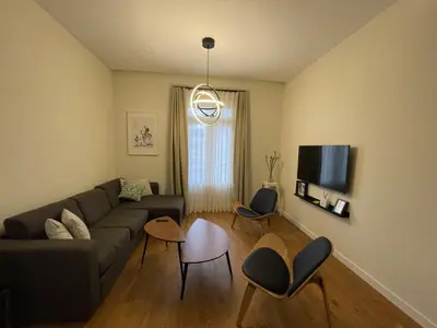 a living room with a couch and a tv at Luxury double Suite at heart of Ruzafa in Valencia