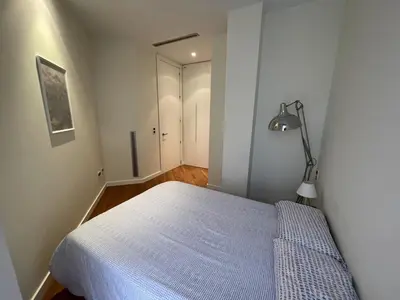 a bedroom with a bed and a lamp in it at Luxury double Suite at heart of Ruzafa in Valencia