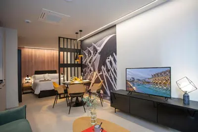 a living room with a television and a bedroom at Neobeds - Stylish modern 1BR Apt Near Old Town & Steps from Turia Park in Valencia