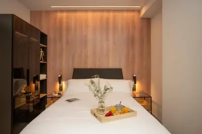 a bedroom with a bed with a tray of fruit on it at Neobeds - Stylish modern 1BR Apt Near Old Town & Steps from Turia Park in Valencia