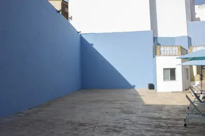 a large blue wall in a building with a patio at El Recreo, private Pool & Bbq in Godelleta
