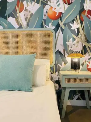 a bedroom with a bed and a wall with flowers at Tarongers, lovely flat in the center in Valencia