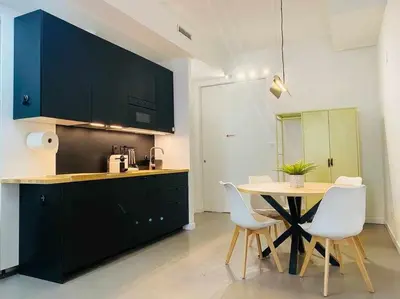 a kitchen with a table and chairs in a kitchen at Tarongers, lovely flat in the center in Valencia