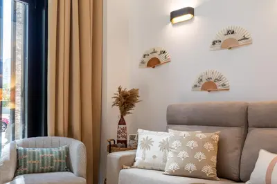 a living room with a couch and a chair at ApartUP Opera Loft Love in Valencia
