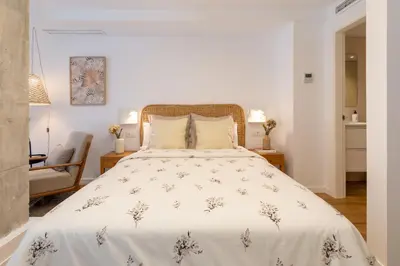 a bedroom with a large bed with a white comforter at ApartUP Opera Loft Love in Valencia