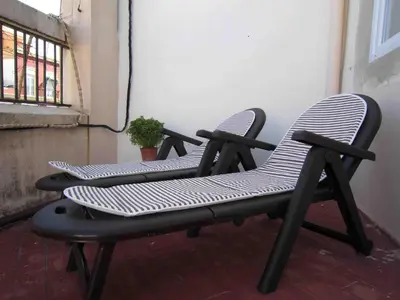 a pair of chairs sitting on a balcony at Young Penthouse in Valencia