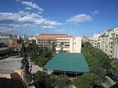 a building with a green roof in a city at Young Penthouse in Valencia