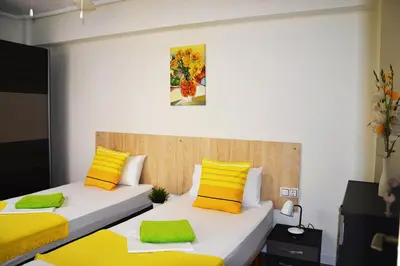 two beds in a room with yellow and yellow pillows at Double cozy room. Ruzafa - perfect place to stay in Valencia