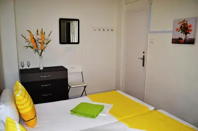 a bedroom with a bed with a yellow blanket at Double cozy room. Ruzafa - perfect place to stay in Valencia