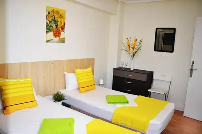 a bedroom with two beds with yellow and white at Double cozy room. Ruzafa - perfect place to stay in Valencia