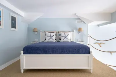 a bedroom with a white bed with blue sheets and pillows at Le Méditarranéen de COUP DE COEUR APPARTEMENTS in Valencia