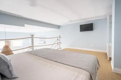 a bedroom with a bed and a tv on the wall at Le Méditarranéen de COUP DE COEUR APPARTEMENTS in Valencia