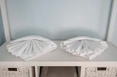 two towels sitting on a shelf in a closet at Le Méditarranéen de COUP DE COEUR APPARTEMENTS in Valencia