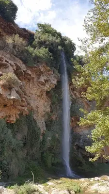 a waterfall on the side of a rocky mountain at Casa El Olmo de Navajas in Navajas