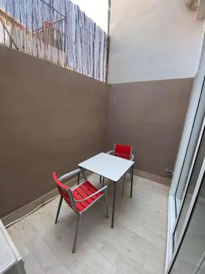 a bedroom with a bed and a table in it at VALENCIA RENT APARTS MILAGROSA 1 in Valencia