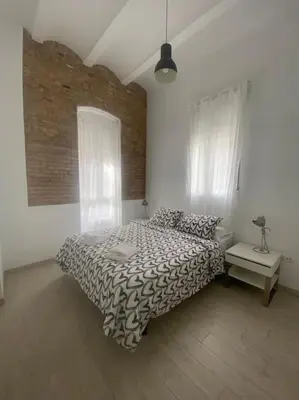 a living room with a couch and a large window at VALENCIA RENT APARTS MILAGROSA 1 in Valencia