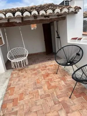 a patio with two chairs and a swing at ruralhome callemayor in Altura