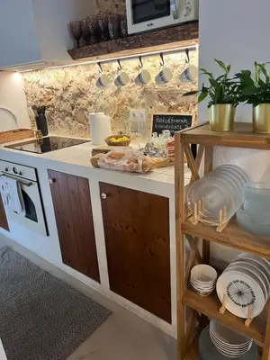 a kitchen with a sink and a counter with dishes at ruralhome callemayor in Altura