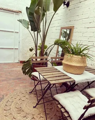 a patio with a wooden table and two chairs at ruralhome callemayor in Altura
