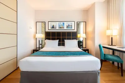 a hotel room with a bed and a desk at Eurostars Gran Valencia in Valencia