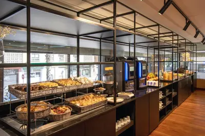 a bakery with many different types of pastries on display at Eurostars Acteón in Valencia