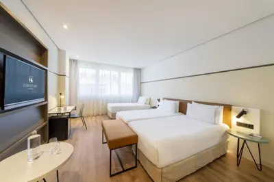 a hotel room with a bed and a flat screen tv at Eurostars Acteón in Valencia