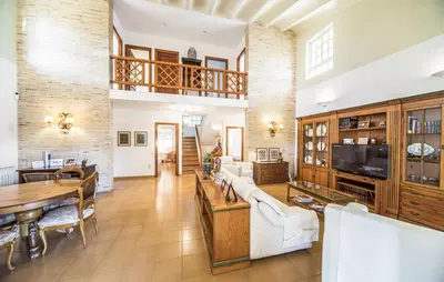 a living room with a couch and a table at Agradable Villa junto al mar con piscina in Sagunto