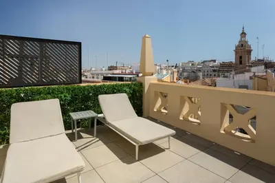 a couple of chairs and a table on a roof at Catalonia Excelsior in Valencia