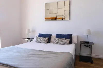 a bedroom with a large white bed with two lamps at Valencia Luxury - Malvarrosa Beach in Valencia