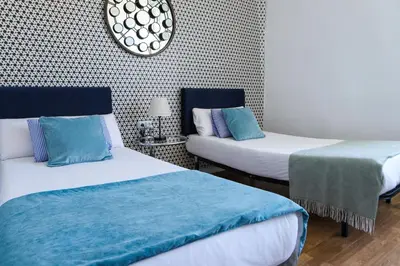 a room with two beds with blue and white at Valencia Luxury - Malvarrosa Beach in Valencia