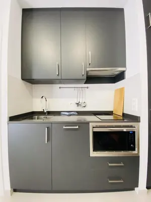 a kitchen with stainless steel cabinets and a sink at RUBEN VELA - LOFT CLOSE to RUSSAFA (SOHO) in Valencia