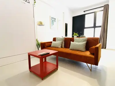 a living room with a couch and a red table at RUBEN VELA - LOFT CLOSE to RUSSAFA (SOHO) in Valencia
