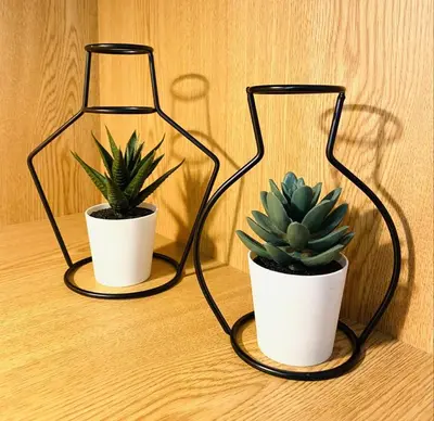 two plants in a glass vase on a table at RUBEN VELA - LOFT CLOSE to RUSSAFA (SOHO) in Valencia