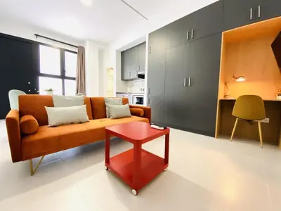 a living room with a couch and a red table at RUBEN VELA - LOFT CLOSE to RUSSAFA (SOHO) in Valencia