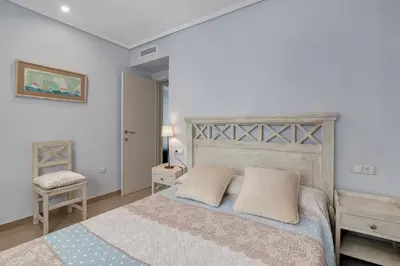 a bedroom with a large bed with two pillows at Ático frente al mar, PataconaBlue, complejo vacacional in Valencia
