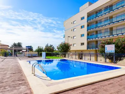 a swimming pool in front of a building at Apartment Las Dunas by Interhome in Moncófar