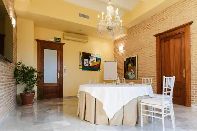 a room with a table with chairs and a chandelier at Ad Hoc Parque in Bétera
