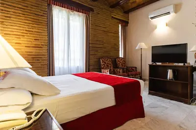 a hotel room with a bed and a flat screen tv at Ad Hoc Monumental 1881 in Valencia