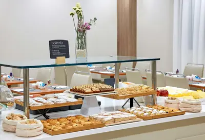 a table filled with different types of pastries at NH Valencia Las Ciencias in Valencia