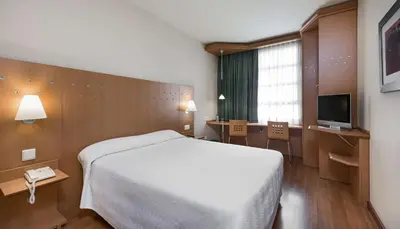 a hotel room with a bed and a television at NH Valencia Las Ciencias in Valencia