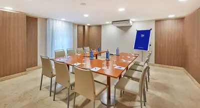 a conference room with a long table and chairs at NH Valencia Las Ciencias in Valencia