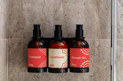 three bottles of hot sauce sitting on a wall at iStay by NH Ciudad de Valencia Hotel in Valencia