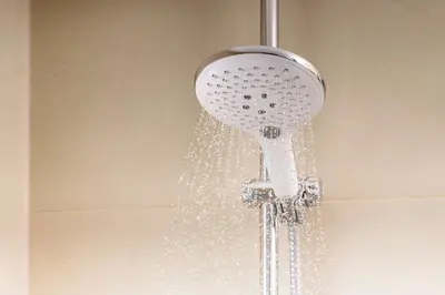 a shower head with water coming out of it at iStay by NH Ciudad de Valencia Hotel in Valencia