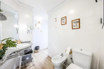 a white bathroom with a toilet and a sink at Lux Penthouse Mediterranean views Beach front in Puerto de Sagunto