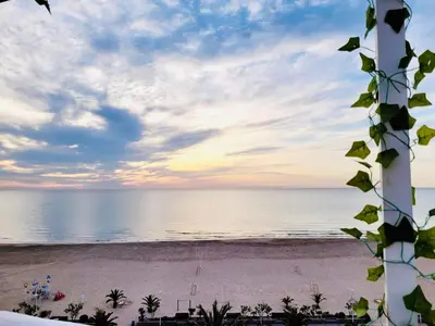 a view of the beach at sunset at Lux Penthouse Mediterranean views Beach front in Puerto de Sagunto