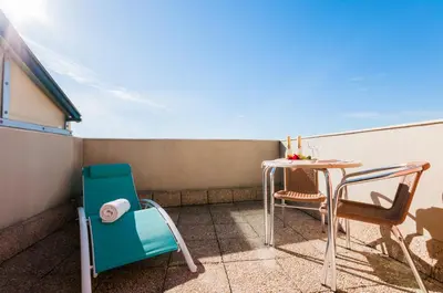 a small balcony with a table and chairs at Hotel Villacarlos in Valencia